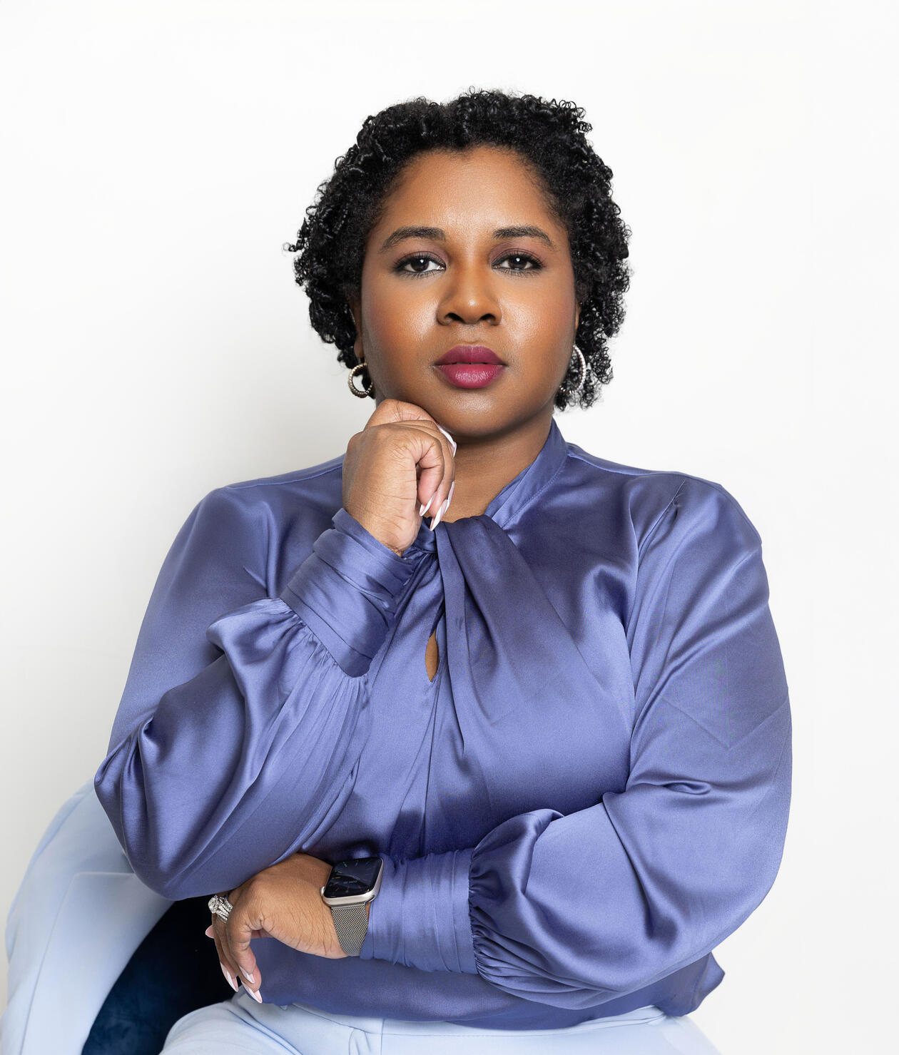 bria-johnson-speaker-headshot.jpg Bria Johnson, featured speaker and Chief Style Strategist, wearing a periwinkle-blue satin blouse in a professional portrait.