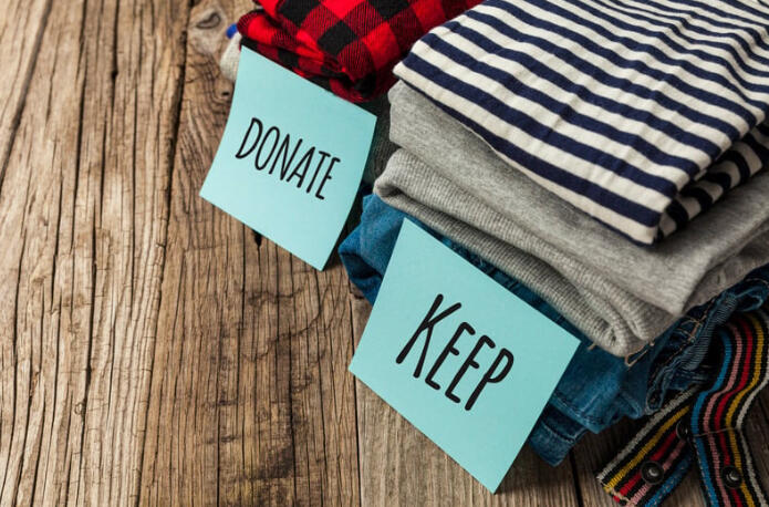 Stacked clothing labeled “donate” and “keep” for the Virtual Wardrobe Reclamation process.
