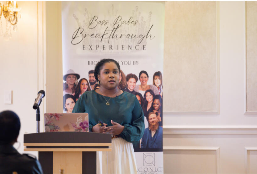 Bria Johnson speaking at the Breakthrough Experience event, presenting on identity, image, and leadership presence as a featured speaker.